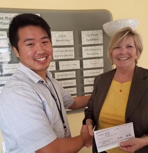 Elbert Guico from DNV-GL for the City of Walnut Creek presents Crisis Center Executive Director, Rhonda James, with a rebate check for improvements in energy efficiency.