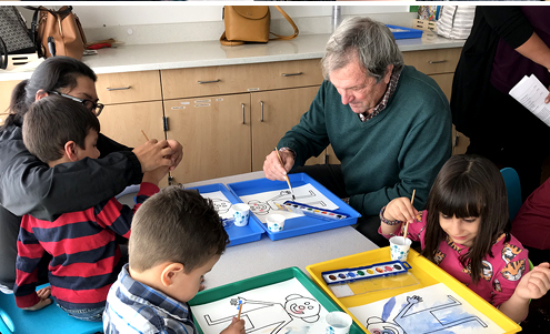 Congressman Mark DeSaulnier paints with preschool children in classroom